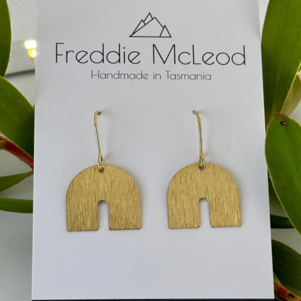 Brass charm earrings by Freddie McLeod