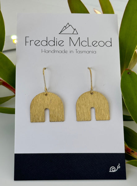 Brass charm earrings by Freddie McLeod